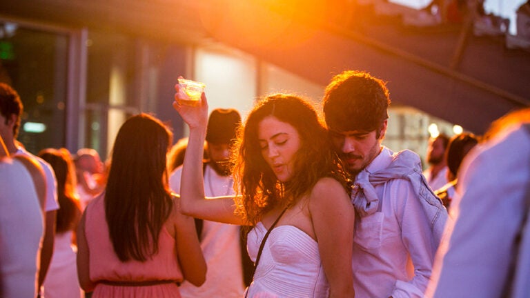Attendees dance at the ICA's White Hot Sunset Waterfront Party