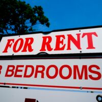 A white sign reading "for rent" in red lettering.