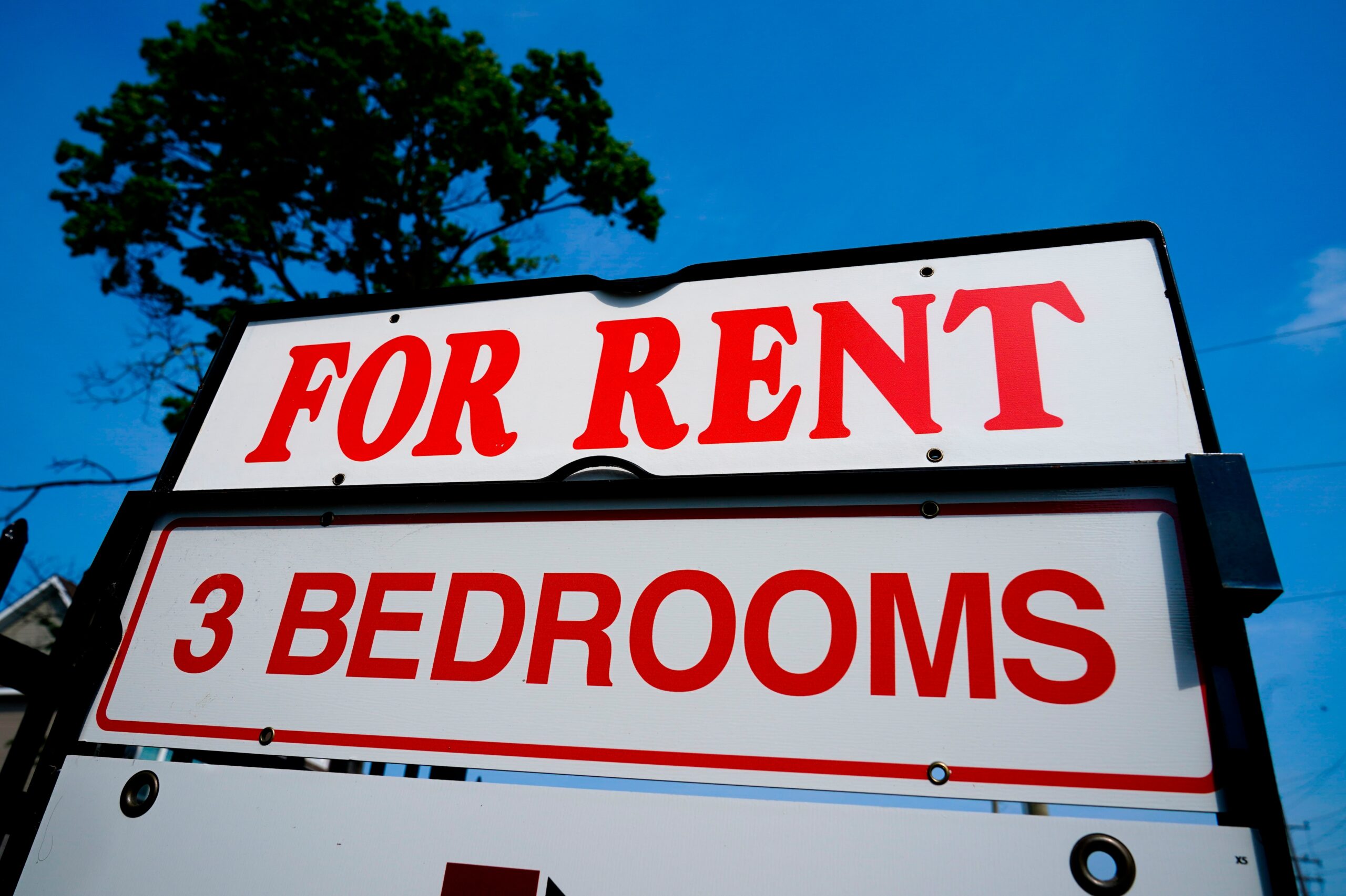 A white sign reading "for rent" in red lettering.