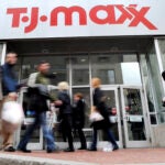 Several people walk past a T.J.Maxx store in Boston.