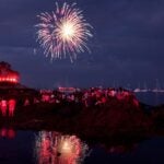 Crowds watch the 2010 Marblehead Fireworks during low tide.