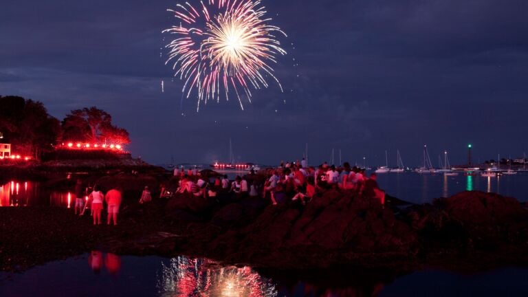 Crowds watch the 2010 Marblehead Fireworks during low tide.