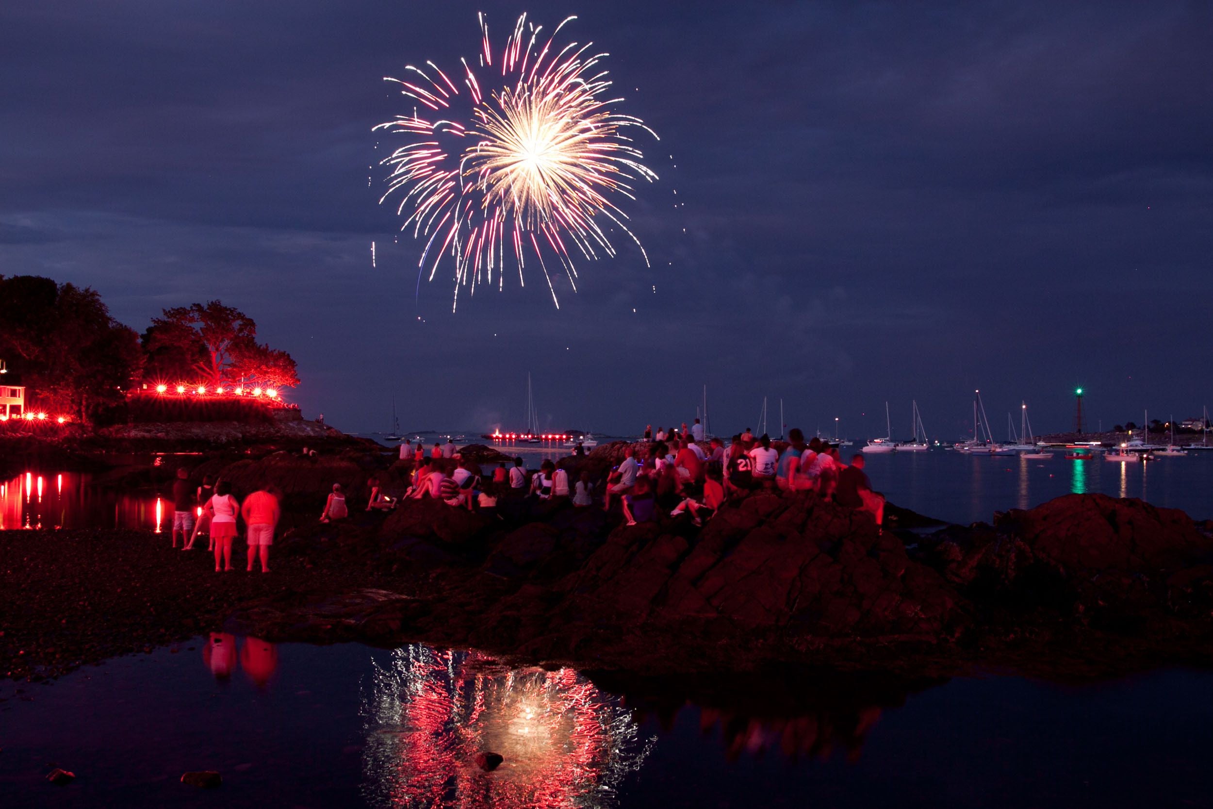 Crowds watch the 2010 Marblehead Fireworks during low tide.