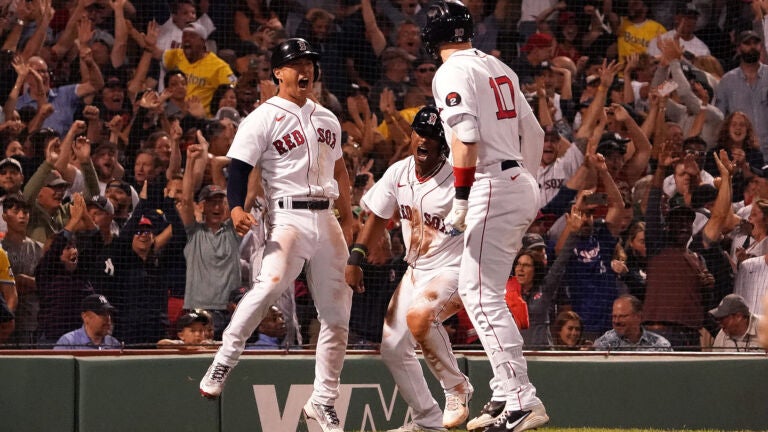 Kiké Hernández walks through the Red Sox dugout as an opponent