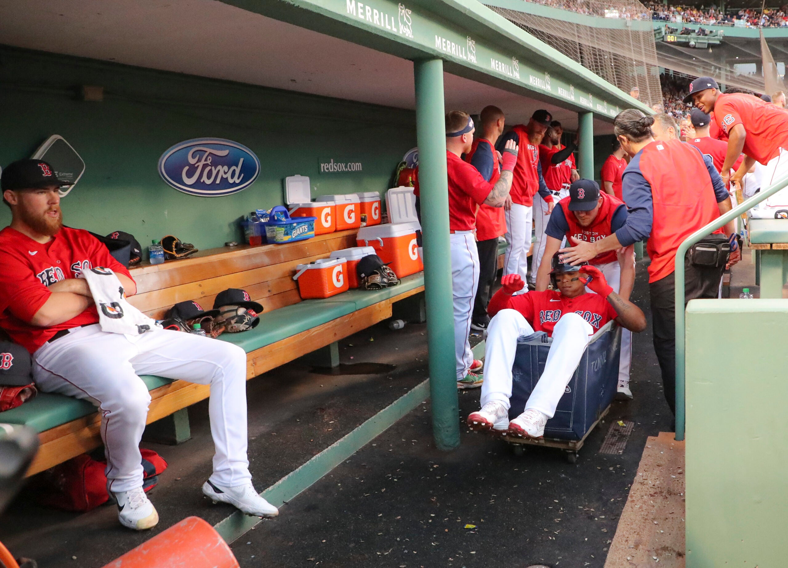 Rafael Devers rides in Red Sox laundry cart.