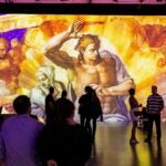 Crowds observe "The Last Judgement" by Michelangelo at "Immersive Vatican."