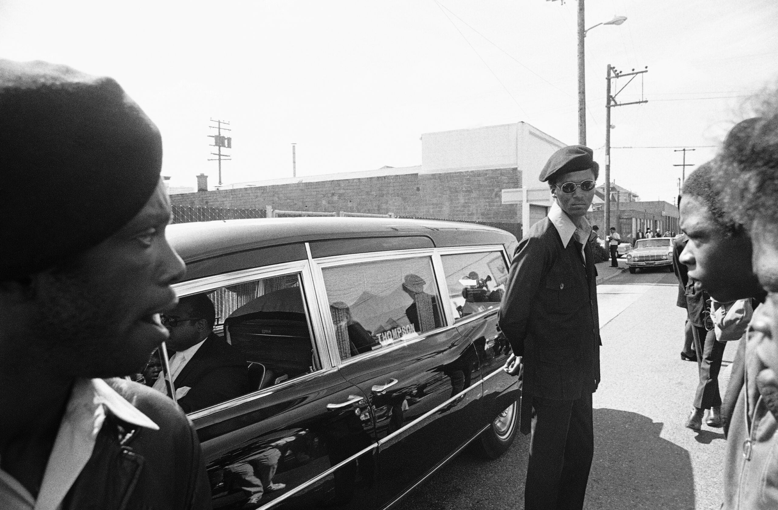 Black Panthers stand guard on Aug. 28, 1971, in Oakland, Calif., while the hearse carrying the body of George Jackson was brought to St. Augustine's Episcopal Church.
