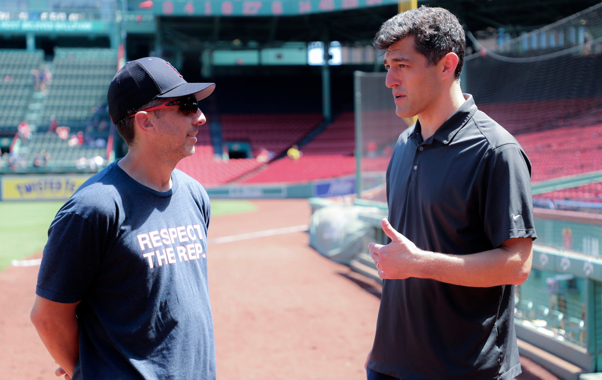Rey Fuentes and Chaim Bloom talking on the field at Fenway Park