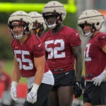 Washington Commanders players wear the Guardian Caps during a training camp practice this summer.