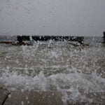 Water splashes over steps at Long Wharf high tide during a snowstorm in downtown Boston, on Jan. 29, 2022.