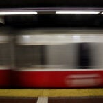 alt = a Red Line train rides through an MBTA station