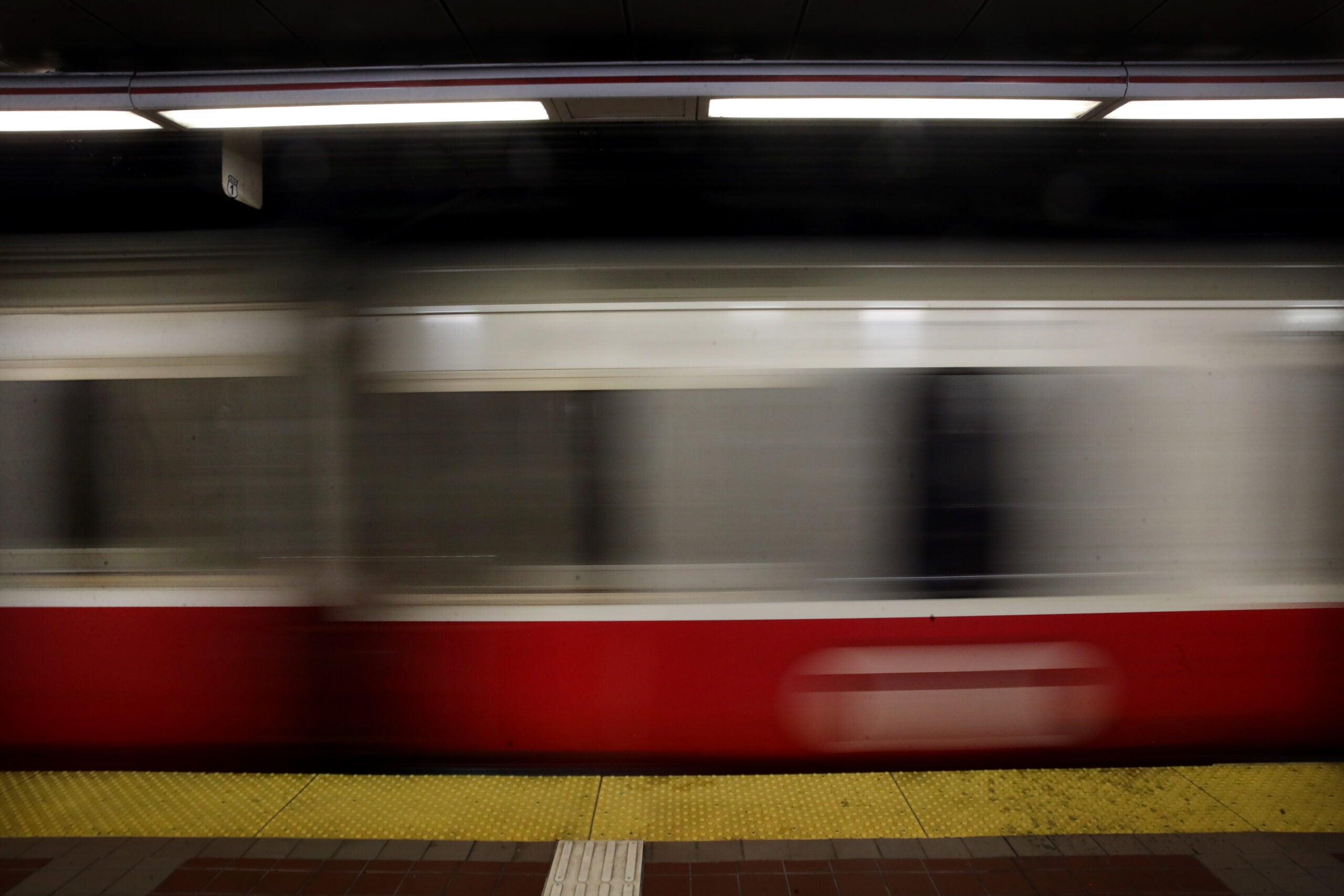 alt = a Red Line train rides through an MBTA station