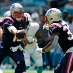 New England Patriots quarterback Mac Jones (10) hands the ball to running back Damien Harris (37) against the Miami Dolphins