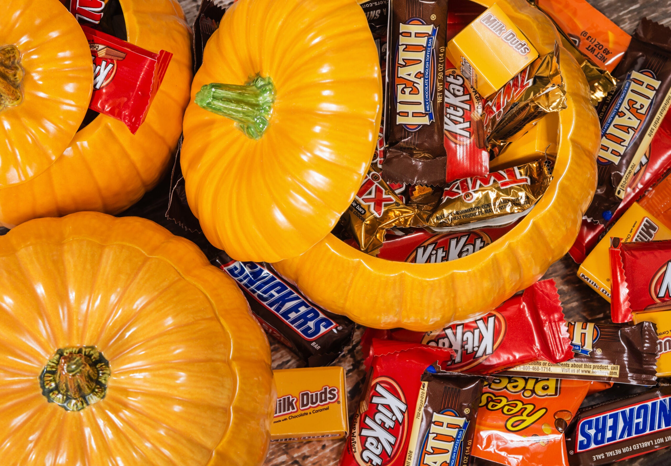 Decorative pumpkins filled with assorted Halloween chocolate can