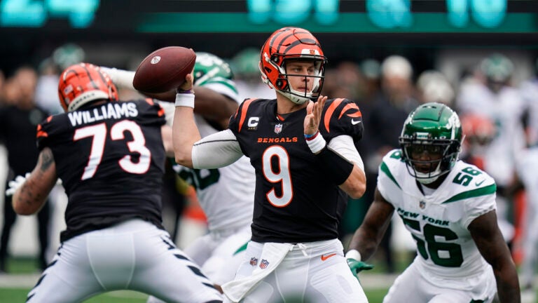 Cincinnati Bengals quarterback Joe Burrow looks to throw a pass during the first half of an NFL football game New York Jets, Sunday, Sept. 25, 2022, in East Rutherford, N.J.