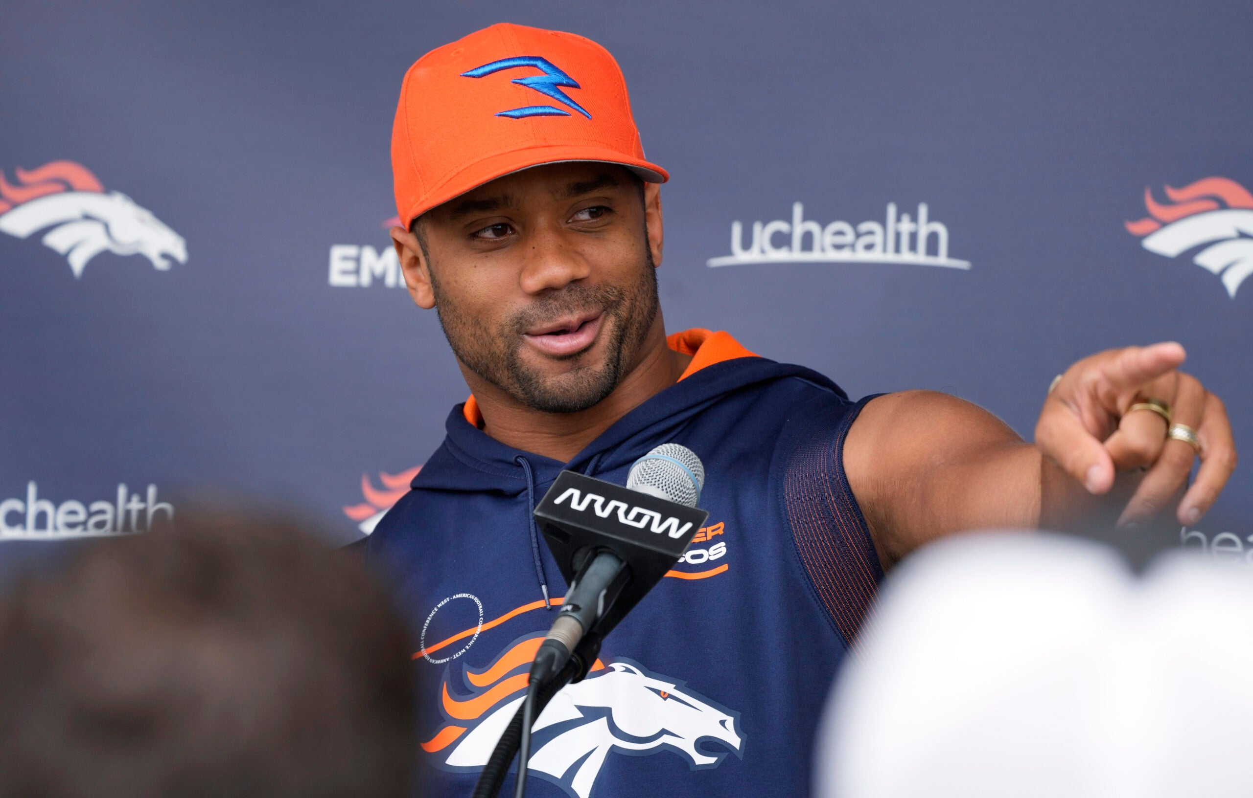 Denver Broncos quarterback Russell Wilson jokes with reporters during a news conference before practice at the NFL team's headquarters Wednesday, Sept. 21, 2022, in Centennial, Colo.