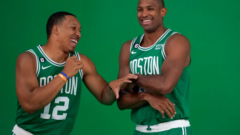 Boston Celtics forward Grant Williams, left, jokes with center Al Horford, right, as the NBA basketball players stand for photos during the team's Media Day, Monday, Sept. 26, 2022, in Canton, Mass