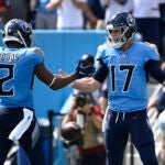 Tennessee Titans quarterback Ryan Tannehill (17) celebrates with Robert Woods (2) after Tannehill ran for a touchdown against the Las Vegas Raiders in the first half of an NFL football game Sunday, Sept. 25, 2022, in Nashville, Tenn.