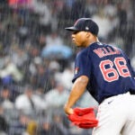 Red Sox pitcher Brayan Bello looks in toward home plate as a heavy rain falls at Yankee Stadium.