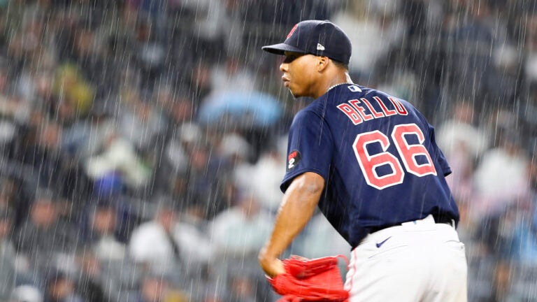 Red Sox pitcher Brayan Bello looks in toward home plate as a heavy rain falls at Yankee Stadium.