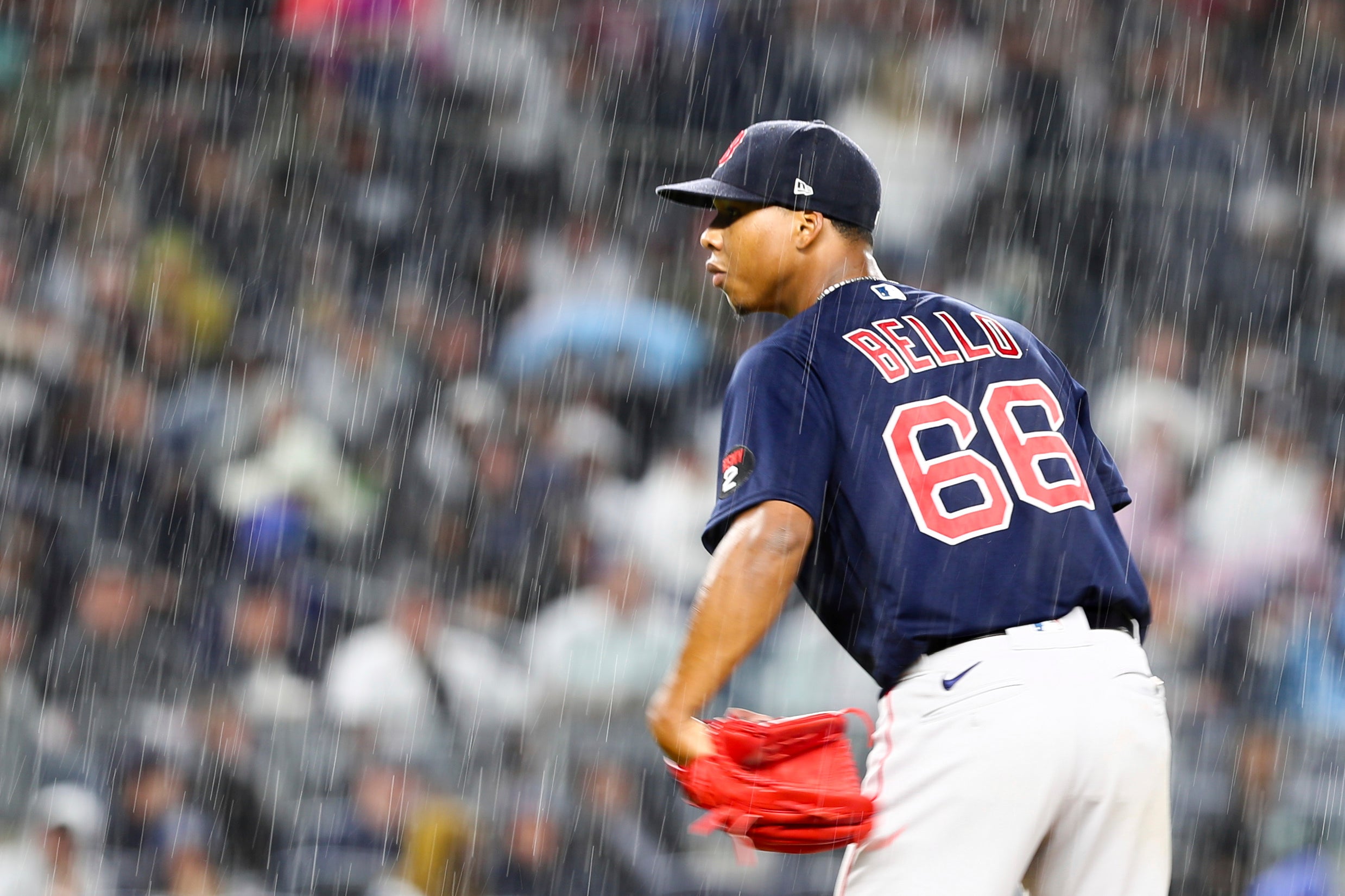 Red Sox pitcher Brayan Bello looks in toward home plate as a heavy rain falls at Yankee Stadium.