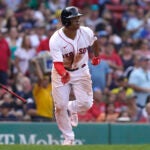 Boston Red Sox's Rafael Devers runs to first after hitting a two-run single in the fifth inning of a baseball game against the Kansas City Royals, Sunday, Sept. 18, 2022, in Boston.