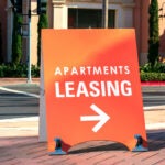 Apartment leasing sign promote the rental property and shows direction where the rental office is located.