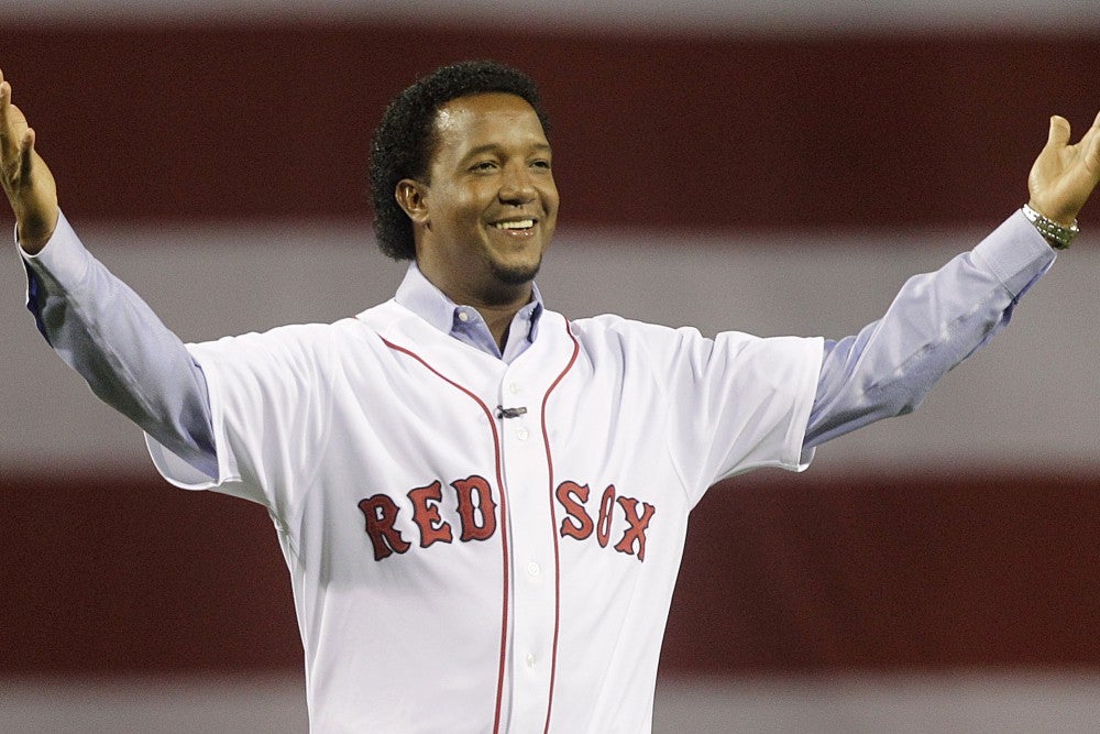 Pedro Martinez waves as he dons his new New York Mets jersey and cap during  a news conference at V Centennary Hotel in Santo Domingo, Dominican  Republic, Friday, Dec. 17, 2004. Martinez