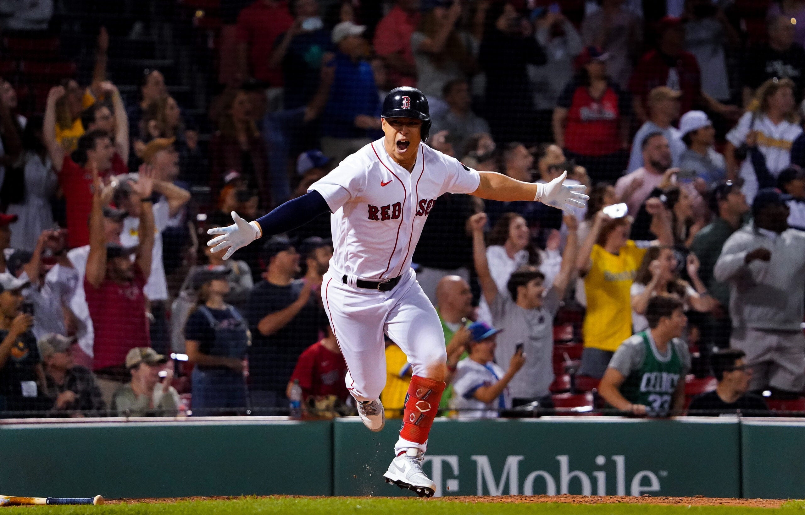 Rob Refsnyder, with his arms outstretched and the crowd beginning to rise behind him, realizes he's delivered the game-winning hit for the Red Sox.