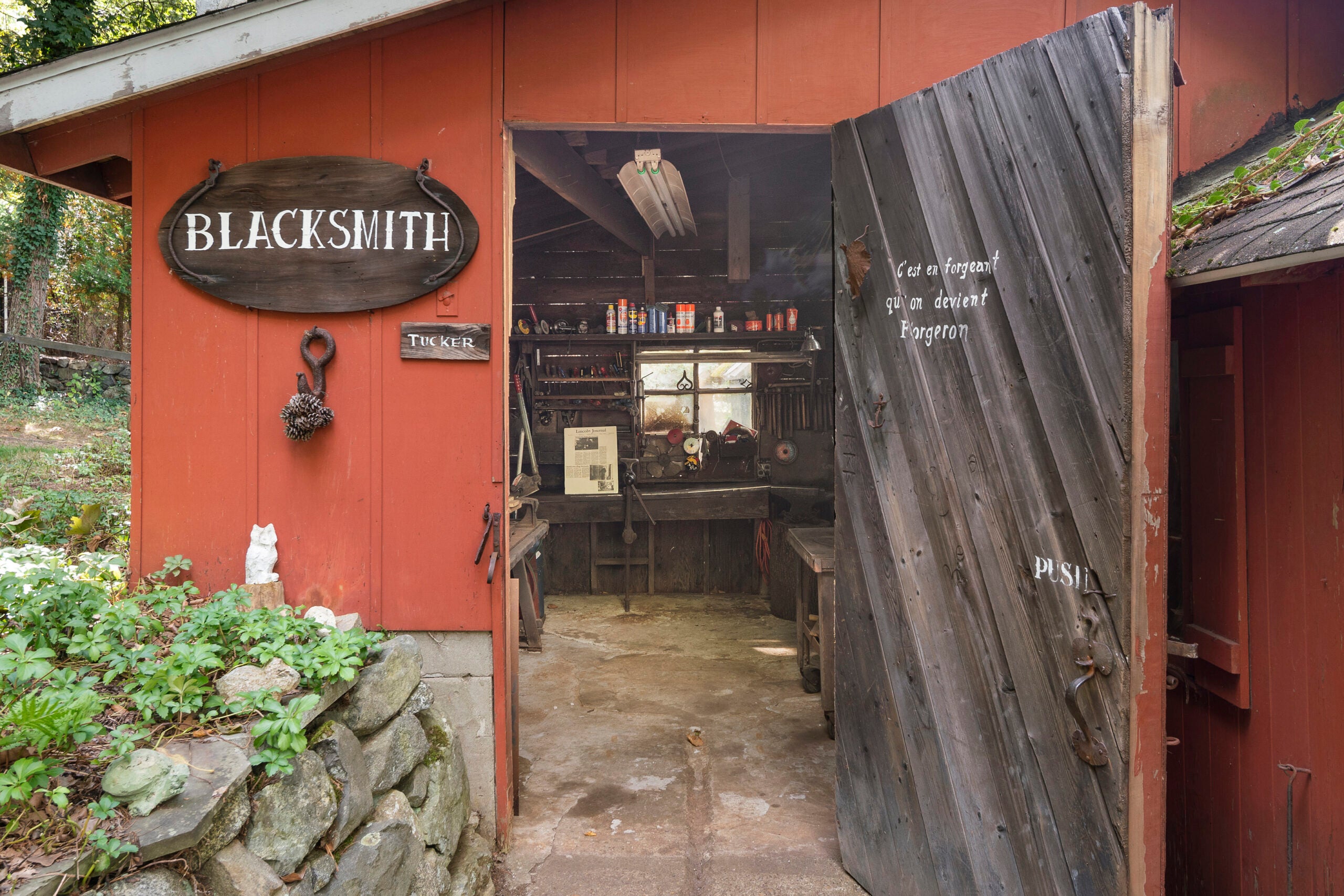 A red workshop with a blacksmith sigh.