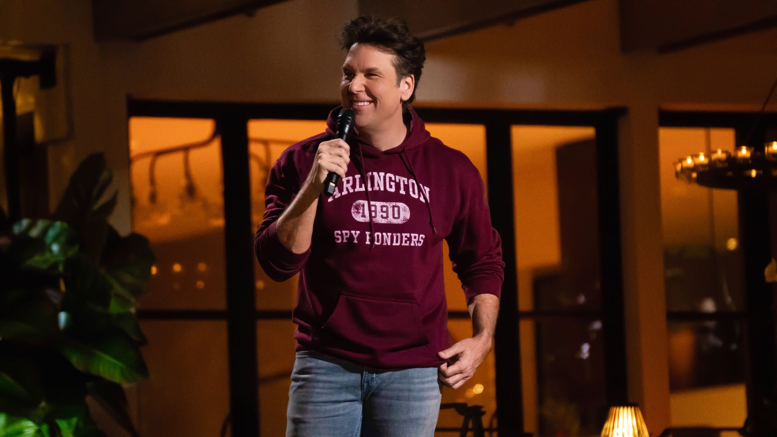 Dane Cook, wearing an Arlington High School sweatshirt, performs in his new stand-up special, "Above It All."