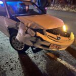 alt = white Honda sedan with Massachusetts license plates and a damaged front end