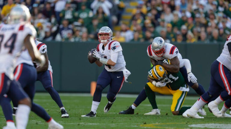 Bailey Zappe scrambles during the Patriots-Packers game.