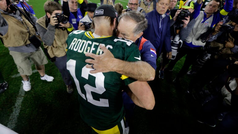 Green Bay Packers quarterback Aaron Rodgers talks with New England Patriots head coach Bill Belichick. AP Photo/Mike Roemer