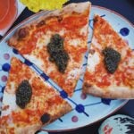 Pizza Project slices draped in caviar at Super Club at The Speedway