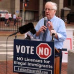 Jim Lyons, chairman of the Massachusetts Republican Party, speaks at a rally in Boston in August.