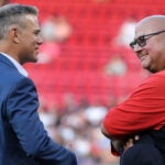 Theo Epstein and Terry Francona exchange smiles as they talk prior to David Ortiz's Hall of Fame celebration at Fenway Park.