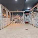 The backdrop of a mountain village with stone building and clay tile roofs.