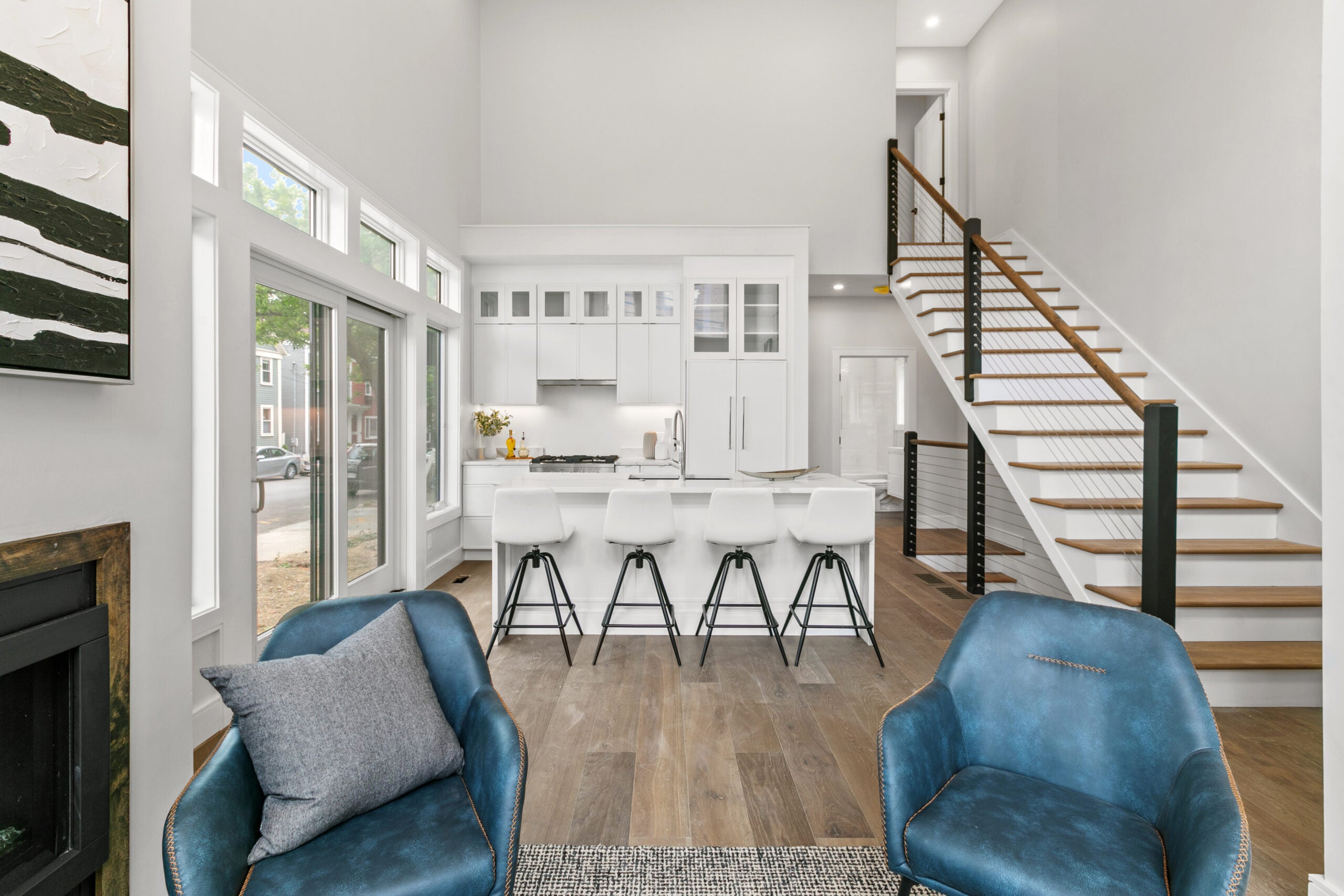 Open living space in 154 Thorndike with stairway to the right of the room, sliding doors to the left and a open living space.