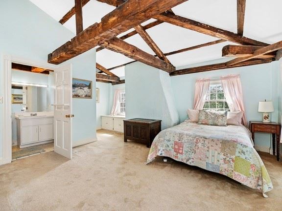 22 Elm Street Boston Bedroom with carpet and wooden beams. 