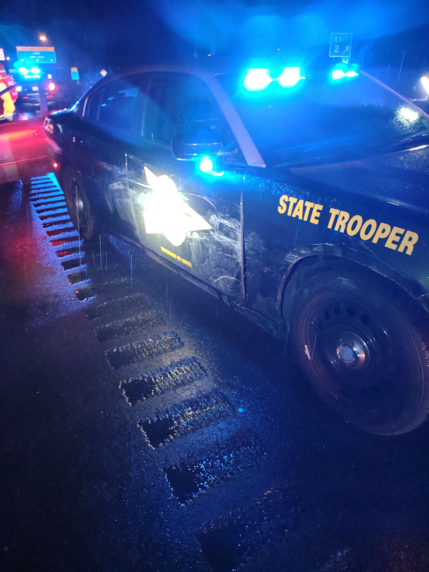alt = a New Hampshire State Trooper's cruiser sustained cosmetic damage to its passenger side when it was used to stop a wrong-way driver on I-95 in New Hampshire.