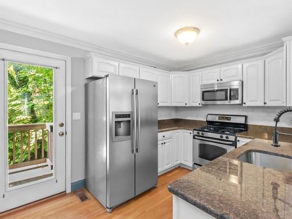 41 Columbus Avenue kitchen with stainless steel appliances and door with class. 