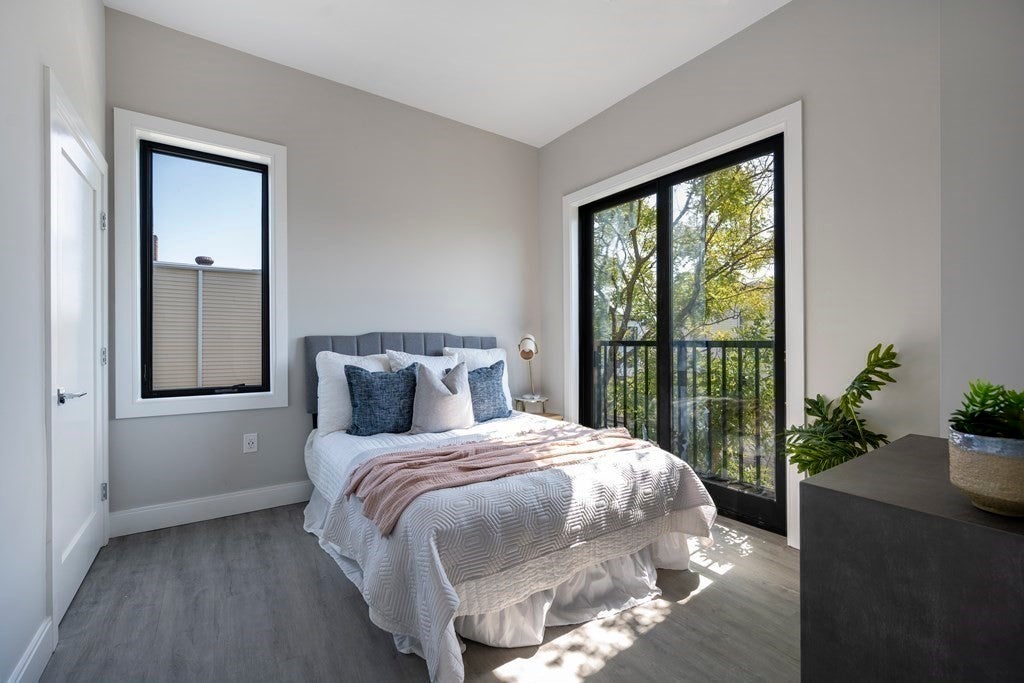 656 Saratoga Bedroom with glass doors and window to let in ample light. Bed is in the center of the room. 