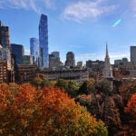Boston, MA - 11/02/2022: A view of the top/crown of colorful trees at the Granary Burying Ground in Boston with the Park Street Church steeple ( on the right ) (David L Ryan/Globe Staff ) SECTION: METRO
