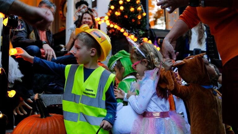 Trick or treaters packed in front of houses for Halloween in the Beacon Hill neighborhood in Boston on Oct. 31, 2022.
