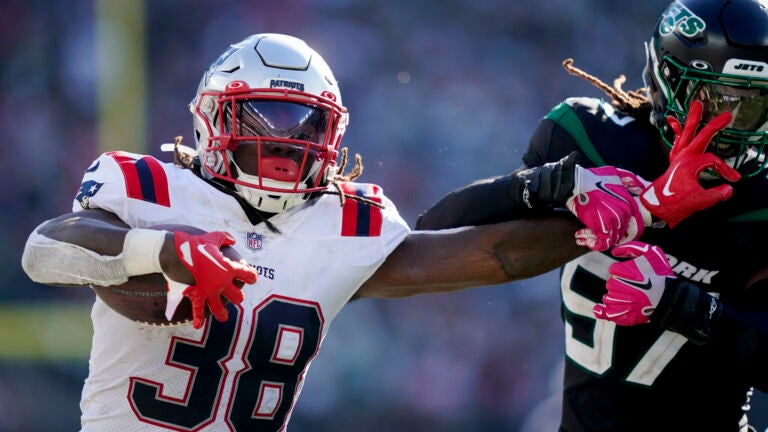 New England Patriots' Rhamondre Stevenson runs against the Detroit