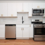 32 Turner Street kitchen with white cabinets and stainless steel appliances.