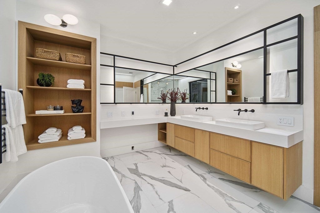 21 Plain Rd bathroom area with tub, storage and sinks.