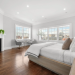 63 Mount Vernon St., Unit PH, Beacon Hill bedroom image with bed in the center of the room and windows on the far side. Fireplace is to the left of the windows.