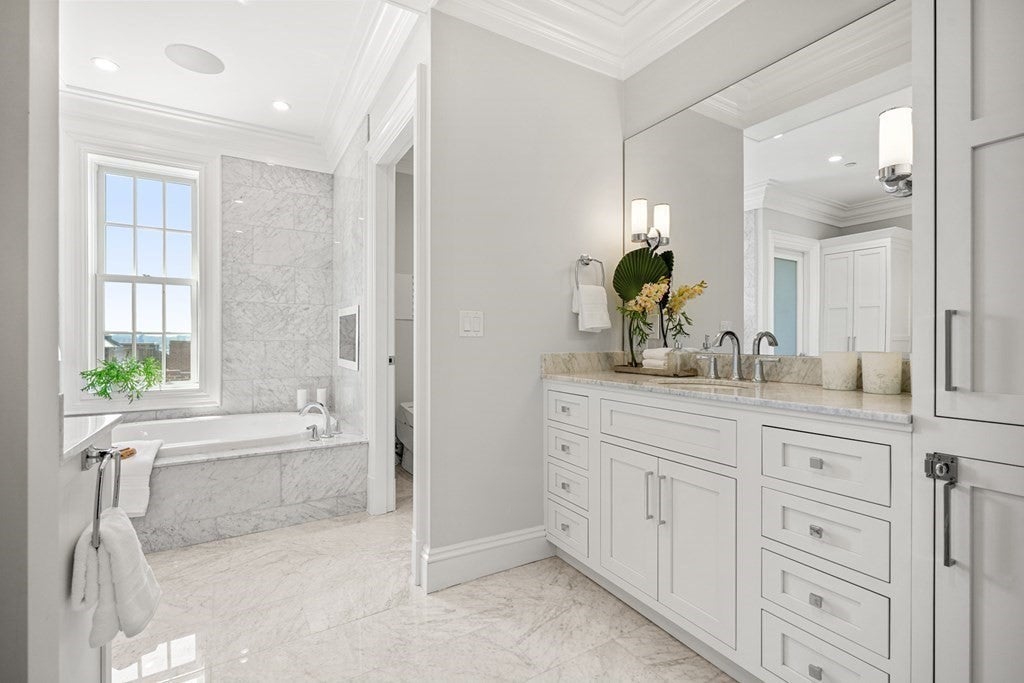63 Mount Vernon bathroom with tub and white cabinets. 